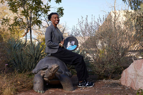 woman posing with framed image of Spock from Star Trek