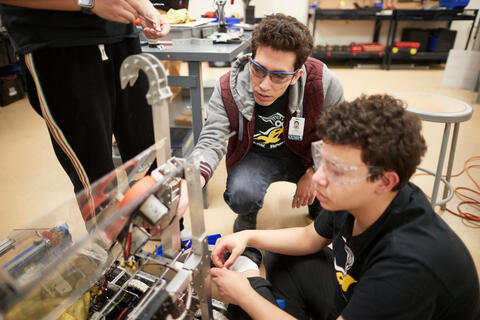 Students Adi Pahima and Magnus Yuen build and programing their robot.