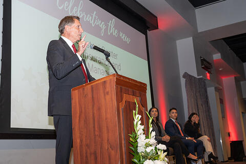 Man standing at a podium speaking