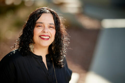 cropped photo of smiling woman with dark hair
