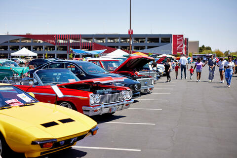 attendees at an outside car show