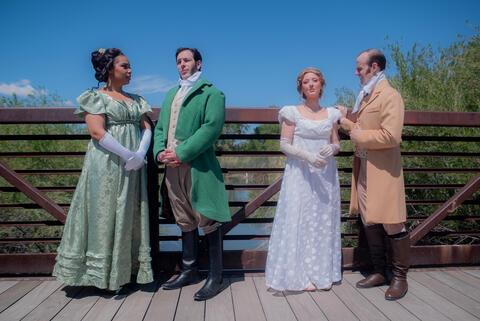 two couples dressed up in 19th century clothing