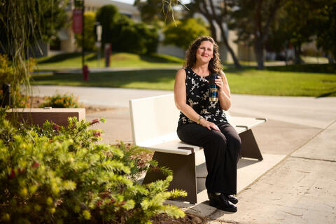 woman holding tall coffee mug that says home means nevada