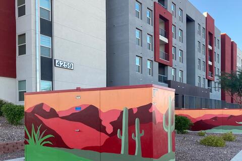 colorful artwork on utility box in front of apartment complex