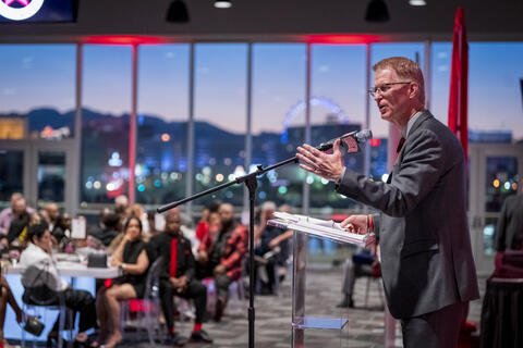 Steve Stallworth speaks to a crowd with the Strip in the background
