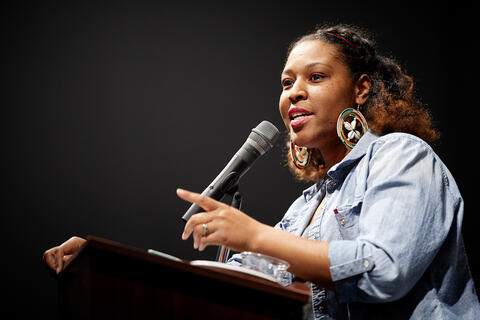 Person on a podium speaking on a mic