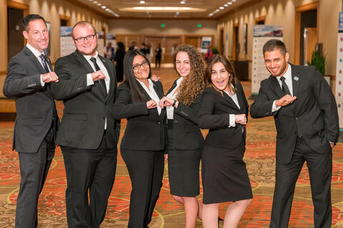 students in business attire standing in a line