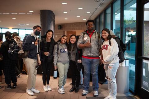 A group of students standing and smiling together.