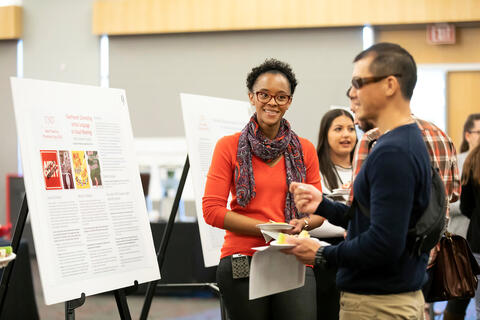 two people talking about an infographic display