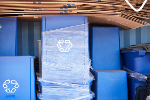 blue recycle bins stacked together