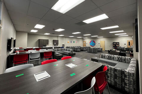 The TLC faculty lounge features a kitchenette, a private lactation room, and a small library you can check out books or board games from. All of the tables and chairs have outlets to charge your devices.