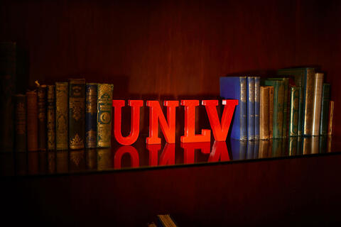 U-N-L-V letters between rows of books
