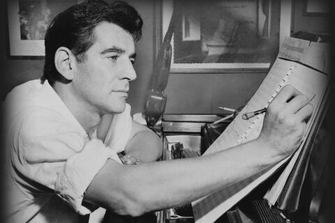 man working on music score