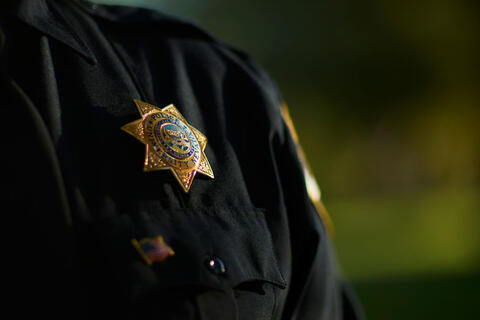 An officer with their badge on their chest