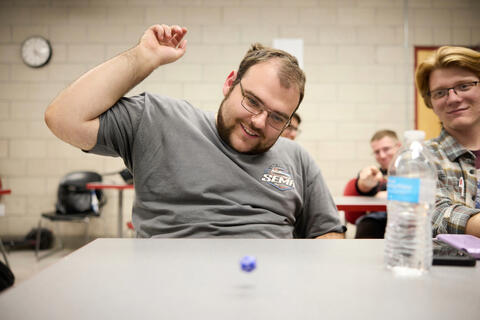 A student rolls a 20-sided dice.