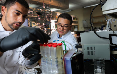 Undergrad researcher Benjamin Sabir helps H. Jeremy Cho examine an atmospheric water harvesting device. (Jeff Scheid/UNLV)