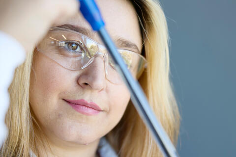 Young woman at a long blue tool