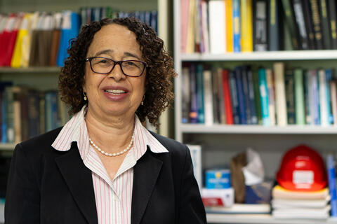 woman posing in front of bookcase