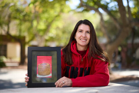 Sabrina Cozine displays daughter's painting of a cake