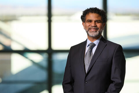 Haroon Sahotra in a black suit and tie