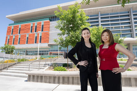 Dr. Corrin Sullivan and Angie Sioco standing in front of the medical education building.
