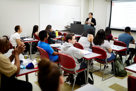 Students with an instructor in front of a classroom