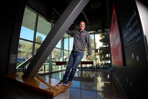 Chris Parker hangs from a low beam in the celebatorium