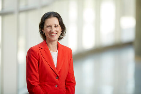 Monika Neda in a red dress suit