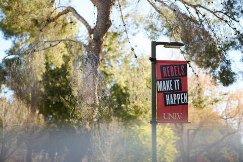 banner on campus that says Rebels Make It Happen