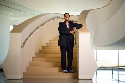 Monique Edwards standing on curved stairway