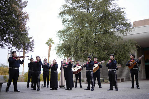 outside photo of large mariachi band in uniforms