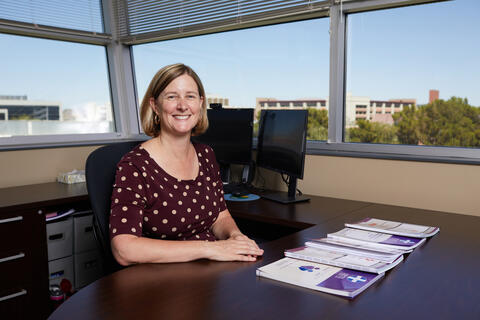Shauna Landis sits at office desk