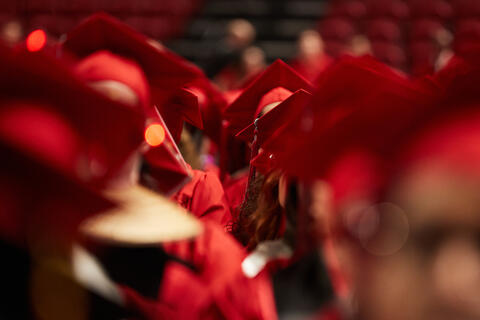 A sea of red mortarboards as students file into UNLV's graduation ceremony at the Thomas &amp; Mack Center
