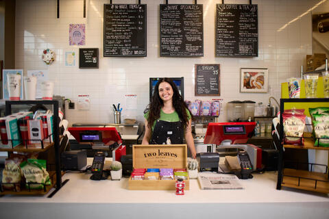 Gina Anderson stands behind counter of Rebel Grounds