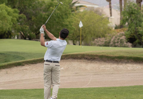 Person in the middle of a golf swing