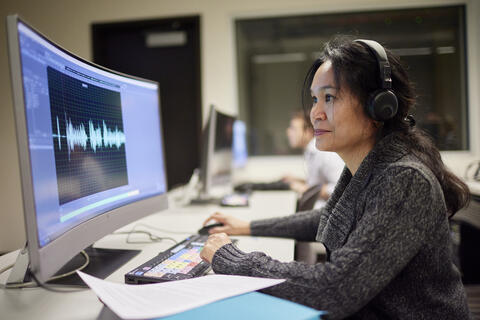 Person watching a line graph on the computer screen