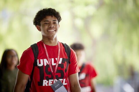 A person wearing a red UNLV shirt