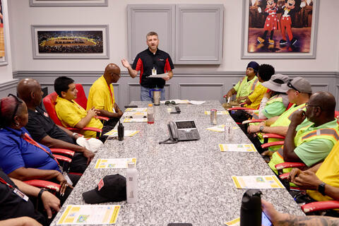 Dan Bollard speaks to a table of event staff