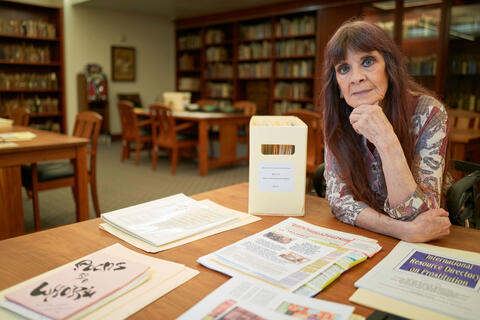 Norma Jean Almadovar, a sex worker rights activist, poses with her collection of documents.