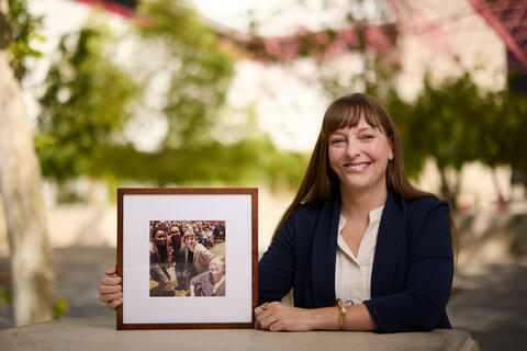 law professor Courtney Cross holding framed photograph