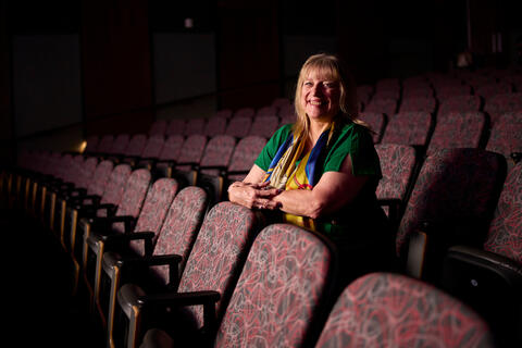 Diane Zapach sitting in the seats of the screening room in FDH 109