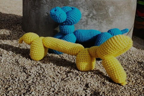 blue and yellow "balloon" animals made out of yarn