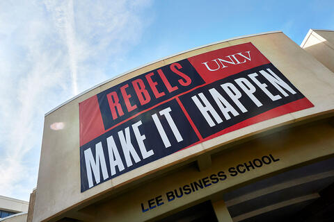A banner on the Frank and Estella Beam Hall that reads "Rebels Make It Happen"