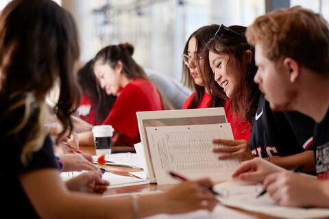 A group of college students studying together at a table.