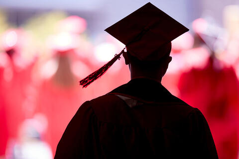 A silhouette of a graduate