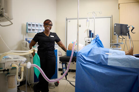 Deborah Byers in scrubs by anesthesia equipment in lab