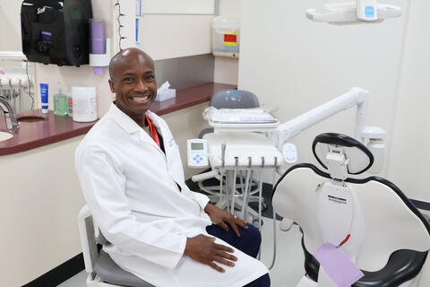 Dr. John Kersey in white dental coat in dentist's office