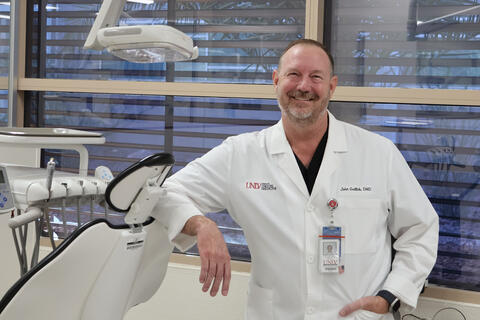 Dr. John Gallob in dental coate and office