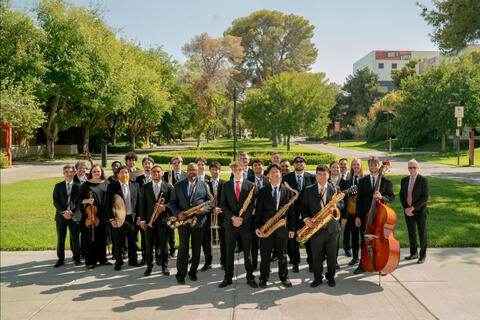 UNLV jazz ensemble outside in dress clothes and holding instruments