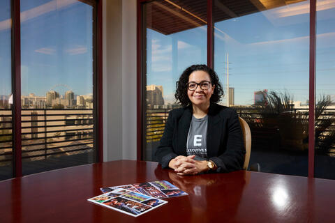 Eliza Wiggins in office with view of Las Vegas Strip